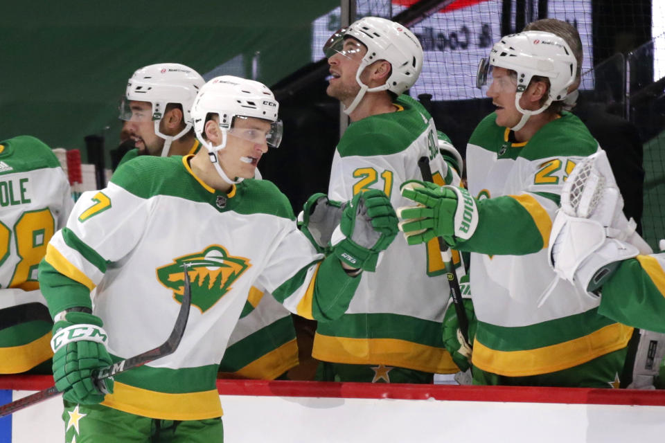 Minnesota Wild center Nico Sturm (7) is congratulated by defenseman Jonas Brodin (25) after scoring against the Los Angeles Kings in the first period during an NHL hockey game, Saturday, Feb. 27, 2021, in St. Paul, Minn. (AP Photo/Andy Clayton-King)