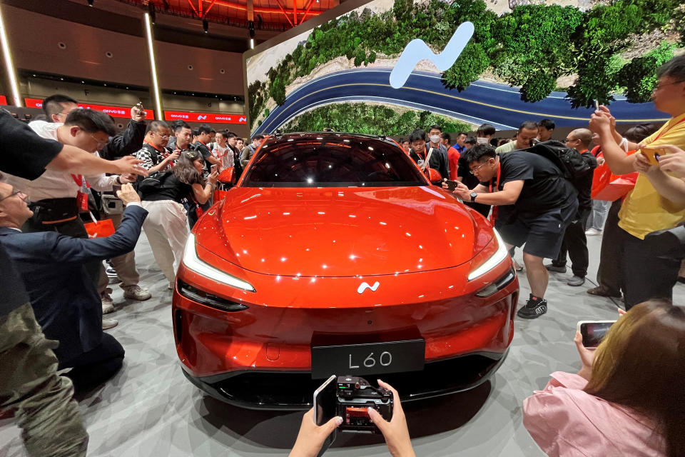 FILE PHOTO: People look at the newly launched Onvo L60 SUV, the first vehicle from Chinese electric vehicle maker Nio's new cheaper brand, in Shanghai, China, May 15, 2024. REUTERS/Zoey Zhang/File Photo