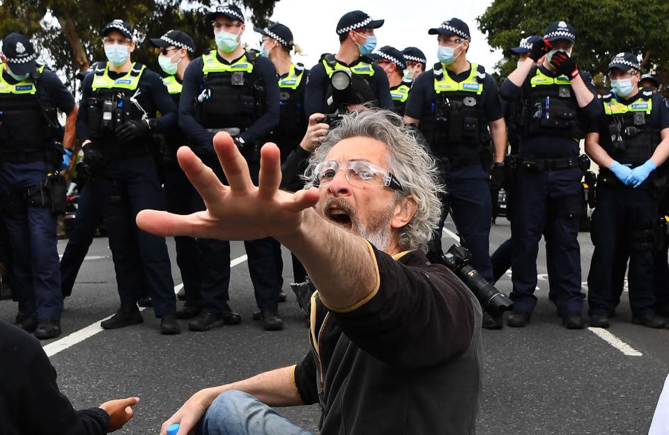 Protesters sat in the road en masse in front of officers (AFP/Getty)
