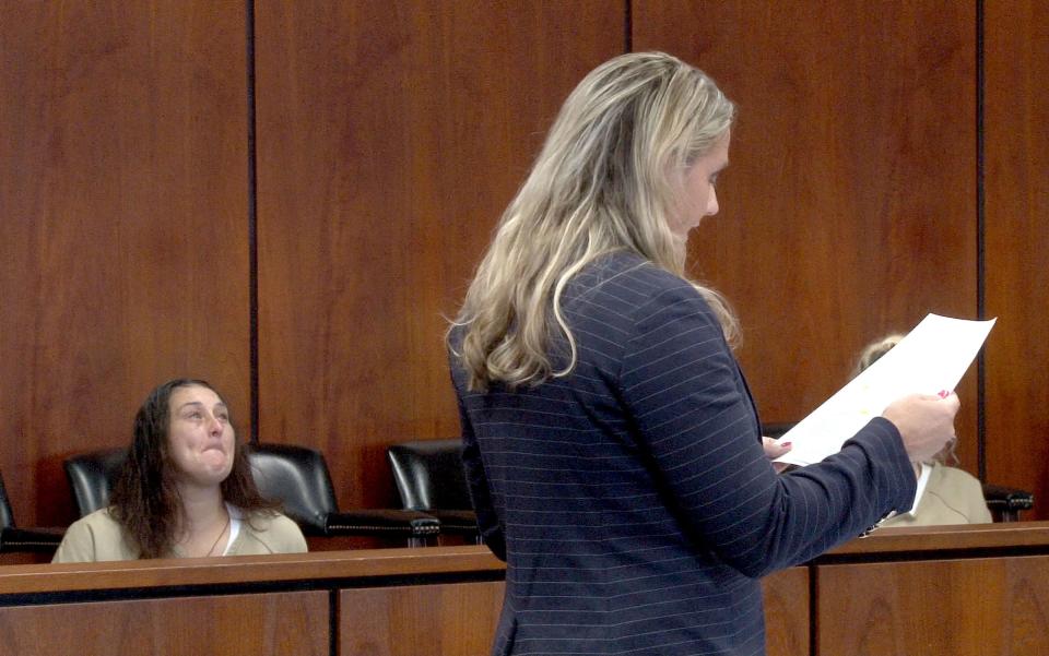 Assistant Ocean County prosecutor Mara Brater reads a letter from the victim's grandmother during the sentencing Helecia Morris (left) for child endangerment before Superior Court Judge Lisa A. Puglisi in Toms River Friday, July 7, 2023.  Morris and her wife Donna Jung were both sentenced for locking their then 8--year-old son in a dark room without furniture for months, without allowing him to use the bathroom.