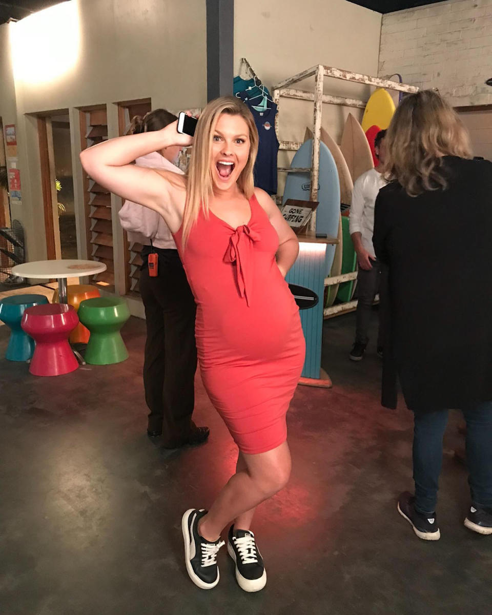 Sophie Dillman as Ziggy Astoni in a tight red dress showing off her pregnant bump