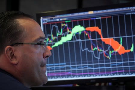 A specialist trader works at his post on the floor at the NYSE in New York