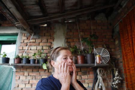 Milica Milkovic, a packaging worker with Serbian farming company Agroziv, stands in her home in the village of Srpski Itebej, near Vrsac July 7, 2014. REUTERS/Djordje Kojadinovic