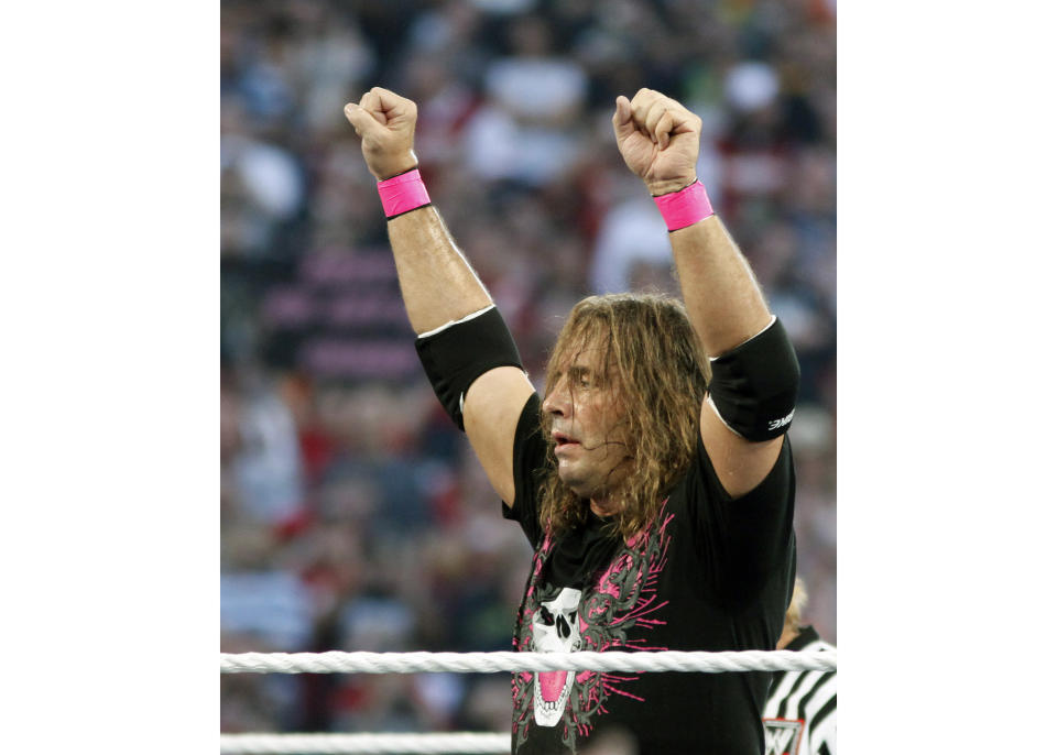 FILE - In this March 28, 2010, file photo, Bret "Hit Man" Hart celebrates his victory over Mr. McMahon at WrestleMania XXVI in Glendale, Ariz. Hart was tackled by a spectator Saturday, April 6, 2019, while he was giving a speech during the WWE Hall of Fame ceremony at Barclays Center. The attacker was promptly subdued by several people, including other wrestlers, who came to Hart's defense. Hart is okay. (AP Photo/Rick Scuteri, File)