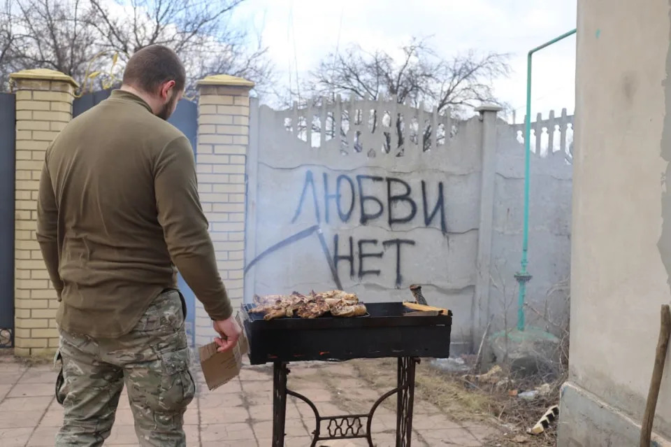 <div class="inline-image__caption"><p>A Ukrainian soldier roasts meat on a barbecue in a backyard in Kramatorsk.</p></div> <div class="inline-image__credit">Tom Mutch</div>