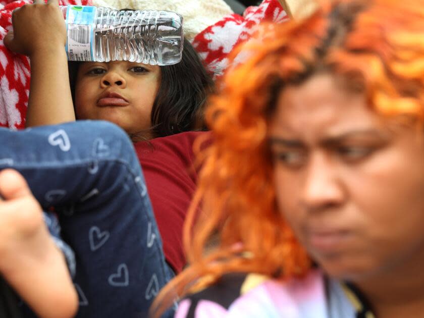 Jaidelin Chacon, right, sits next to her daughter Celeste, 5, who 