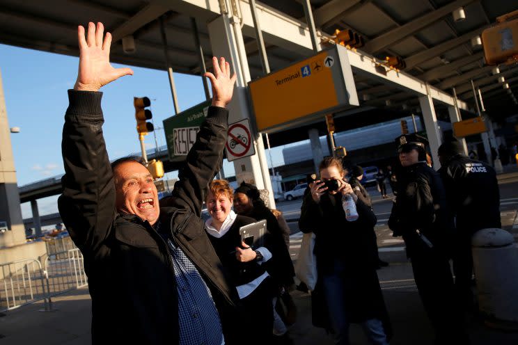 Zabihollah Zarepisheh of Iran celebrates after being released from detention at John F. Kennedy International Airport in New York on Sunday. (Photo: Andrew Kelly/Reuters)