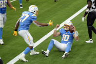 Los Angeles Chargers quarterback Justin Herbert (10) celebrates his rushing touchdown with Joshua Kelley (27) during the second half of an NFL football game against the Jacksonville Jaguars Sunday, Oct. 25, 2020, in Inglewood, Calif. (AP Photo/Kyusung Gong)