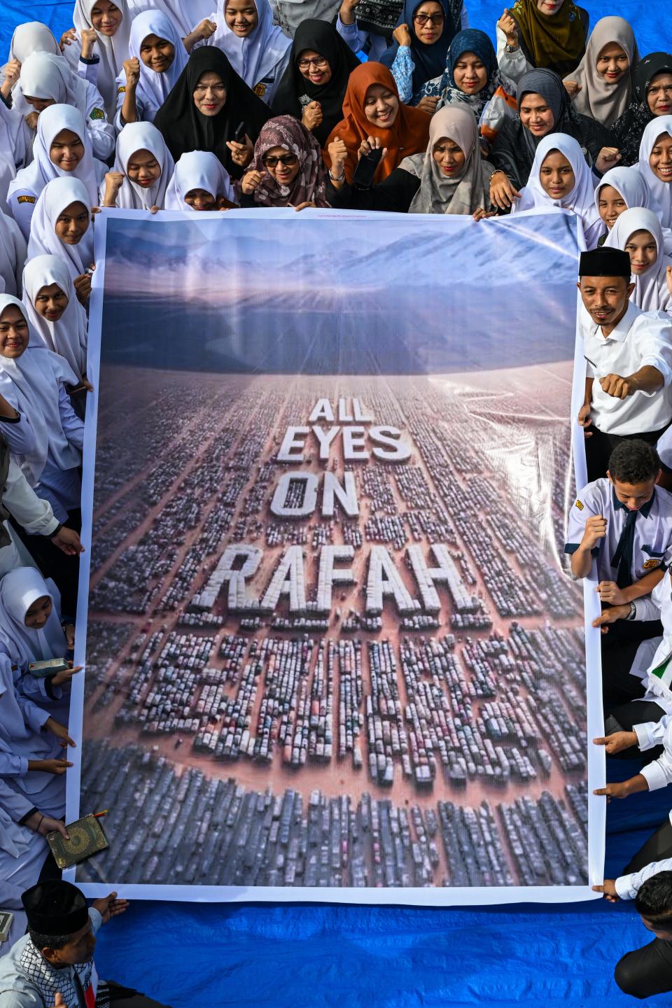 Muslim students hold a banner of "All Eyes on Rafah" image, generated by artificial intelligence, in Banda Aceh, Indonesia, on June 4, 2024.