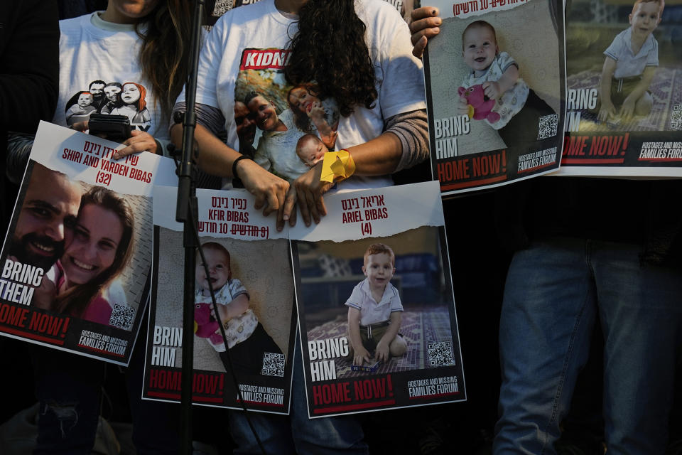 Israeli protesters call for the release of the Bibas family, whose members are being held hostage in the Gaza Strip by the Hamas militant group, in Tel Aviv, Tuesday, Nov. 28, 2023. Hamas has released over 50 Israeli hostages in recent days as part of a cease-fire agreement, but it still holds dozens of others, including the Bibas family. The family's 10-month-old son Kfir is the youngest hostage in Hamas captivity. (AP Photo/Ariel Schalit)