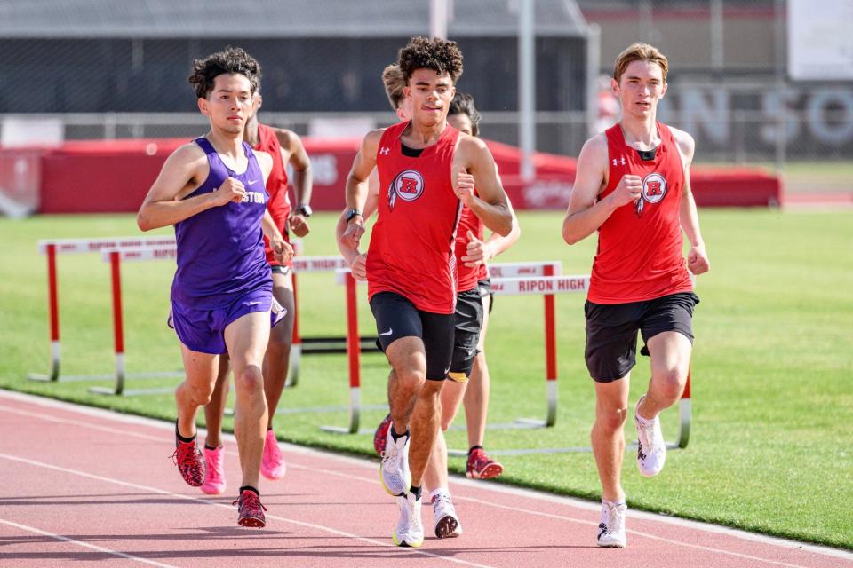 Ripon's Devin Fitzpatrick (center) and Luke Bair (right) run in a race during one of the Indians track meets during the 2023-24 season.