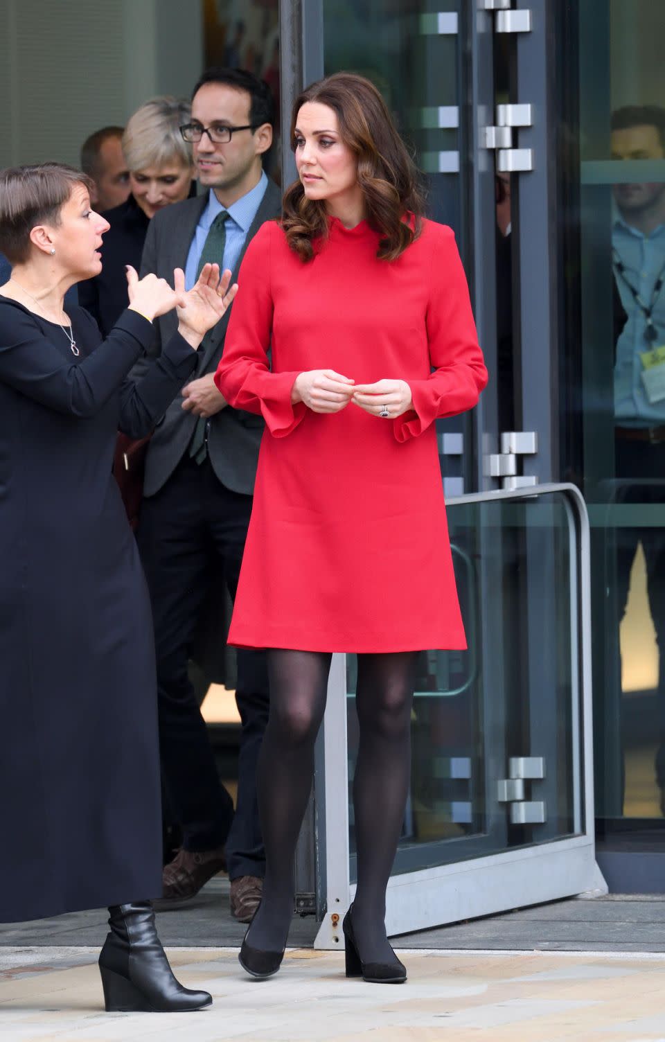 Underneath the coat she has a stunning red Goat dress on. Photo: Getty Images