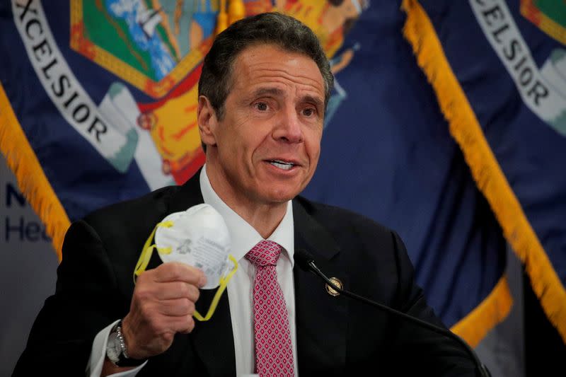 New York Governor Andrew Cuomo shows a face mask at a daily briefing at North Shore University Hospital, during the outbreak of the coronavirus disease (COVID-19) in Manhasset, New York