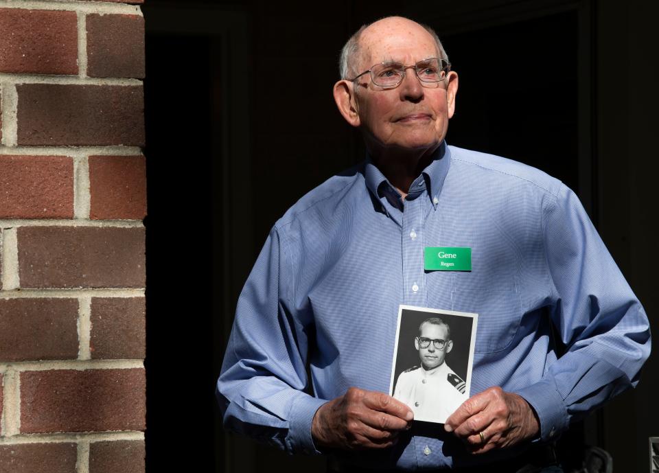 Retired orthopedic surgeon Gene Regen holds a picture of himself in Navy dress uniform taken during his service from 1960 to 1962. He's at his home in Nashville, Tenn., Wednesday, Nov. 1, 2023.