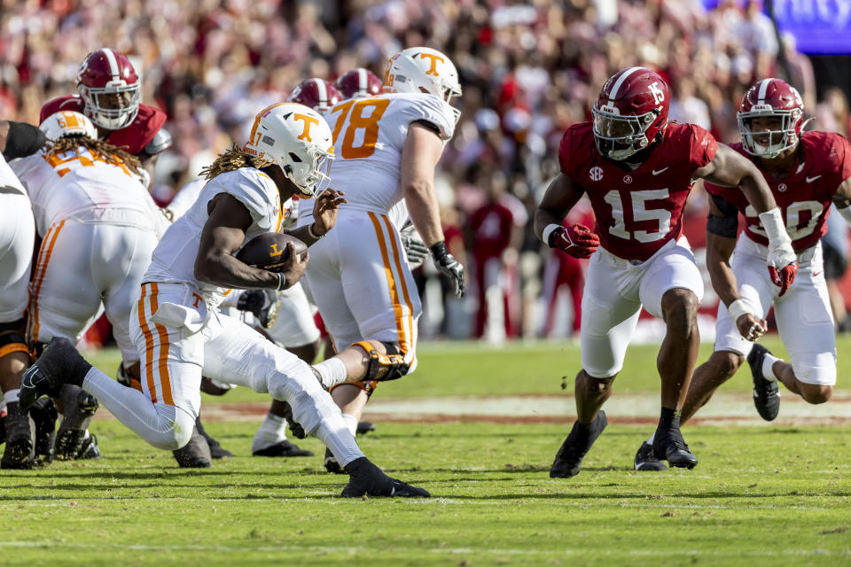 Tennessee quarterback Joe Milton III (7) faces off against Alabama linebacker Dallas Turner (15) during the first half of an NCAA college football game, Saturday, Oct. 21, 2023, in Tuscaloosa, Ala. (AP Photo/Vasha Hunt)