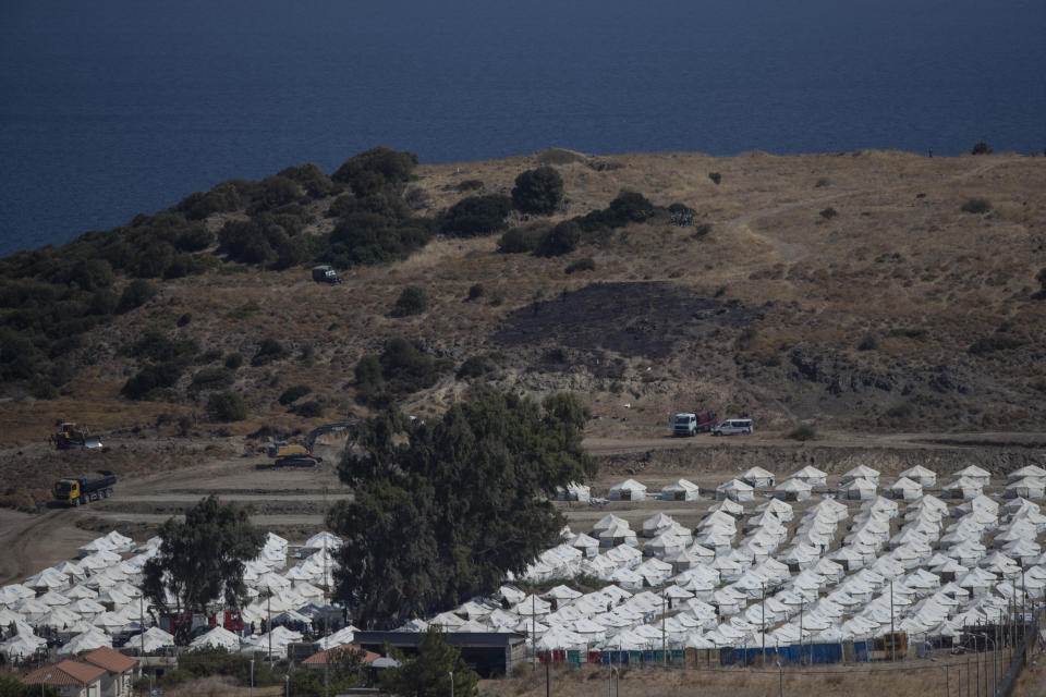 A general view of the temporary camp for refugees and migrants near Mytilene town, on the northeastern island of Lesbos, Greece, Sunday Sept. 13, 2020. Greek authorities have been scrambling to find a way to house more than 12,000 people left in need of emergency shelter on the island after the fires deliberately set on Tuesday and Wednesday night gutted the Moria refugee camp. (AP Photo/Petros Giannakouris)