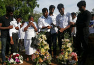 People react during a mass burial of victims, two days after a string of suicide bomb attacks on churches and luxury hotels across the island on Easter Sunday, at a cemetery near St. Sebastian Church in Negombo, Sri Lanka April 23, 2019. REUTERS/Athit Perawongmetha