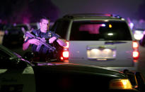 <p>A San Diego Harbor Police officer helps to secure the scene near the corner of 39th Street and Boston Avenue in San Diego near where two San Diego Police officers were shot Thursday night, July 28, 2016. (John Gastaldo/The San Diego Union-Tribune via AP)</p>