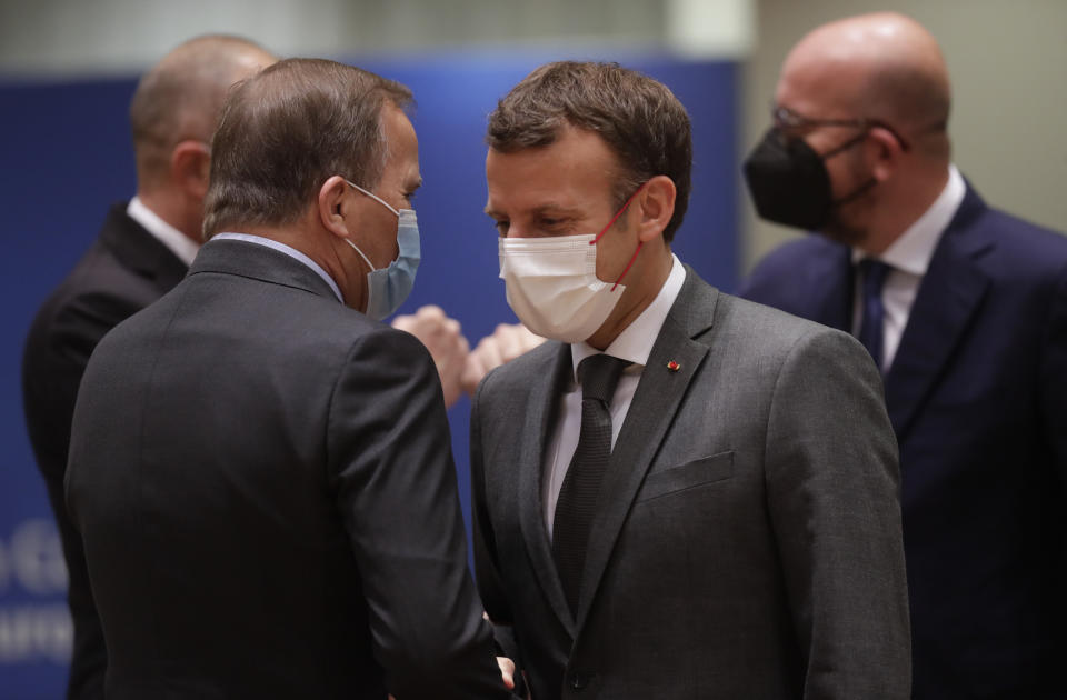 French President Emmanuel Macron, right, talks to Sweden's Prime Minister Stefan Lofven during an EU summit at the European Council building in Brussels, Friday, June 25, 2021. During the second of two days summit EU leaders are discussing the economic challenges the bloc faces due to coronavirus restrictions and will review progress on their banking union and capital markets union. (Olivier Hoslet, Pool Photo via AP)