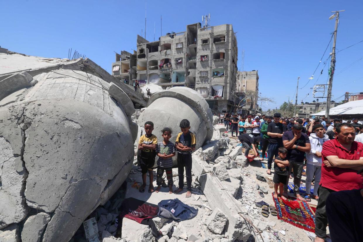 <span>Palestinians in Rafah perform Friday prayers next to the ruins of al-Farouq mosque, which was destroyed by Israeli bombardment.</span><span>Photograph: Mohammed Abed/AFP/Getty Images</span>