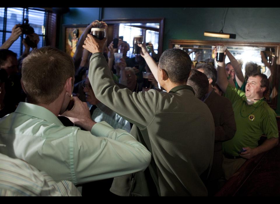 Obama raises his glass while drinking Guinness at The Dubliner pub on March 17, 2012 in Washington. Obama went to the bar to celebrate St. Patrick's Day. AFP PHOTO/Brendan SMIALOWSKI