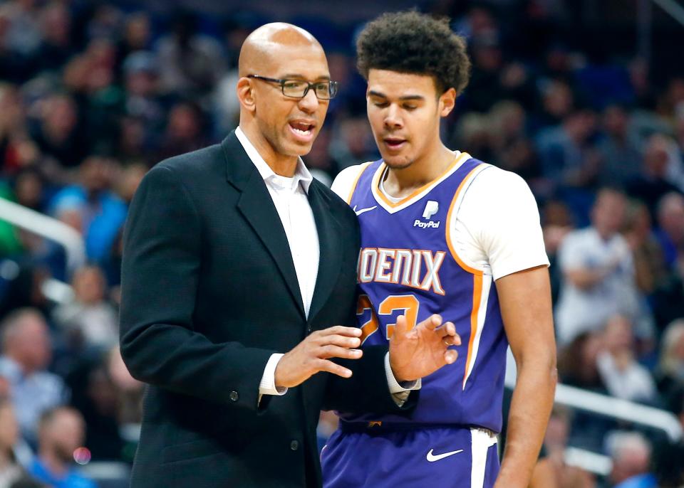 Phoenix Suns forward Cameron Johnson talks with Suns head coach Monty Williams during a game against the Orlando Magic at Amway Center, Dec. 4, 2019 in Orlando.