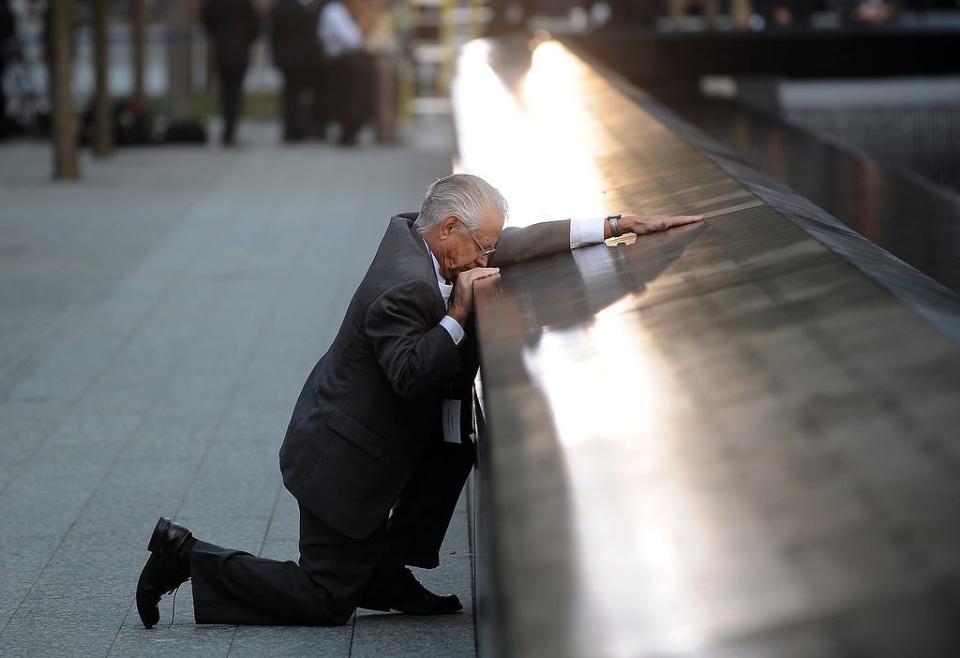 Robert Peraza, who lost his son, Warren County native Robert David Peraza, in the attacks at the World Trade Center, pauses at his son's name at the North Pool of the 9/11 Memorial before the 10th anniversary ceremony at the site, Sunday Sept. 11, 2011, in New York.