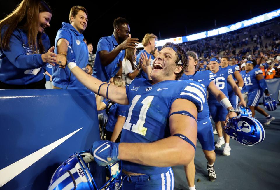 BYU players greet fans after winning a football game against the Cincinnati Bearcats at LaVell Edwards Stadium in Provo on Friday, Sept. 29, 2023. BYU won 35-27. | Kristin Murphy, Deseret News