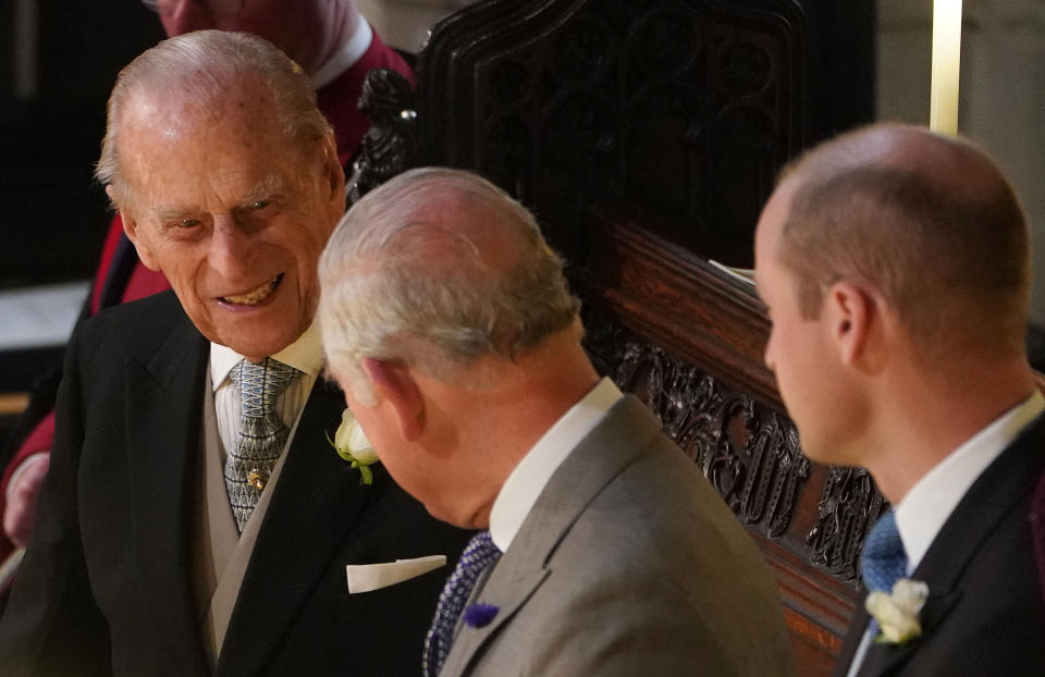 Britain's Prince Philip, Duke of Edinburgh (L), Britain's Prince Charles, Prince of Wales (C) and Britain's Prince William, Duke of Cambridge, react during the wedding ceremony of Britain's Princess Eugenie of York to Jack Brooksbank at St George's Chapel, Windsor Castle, in Windsor, on October 12, 2018. (Photo by Owen Humphreys / POOL / AFP)        (Photo credit should read OWEN HUMPHREYS/AFP via Getty Images)