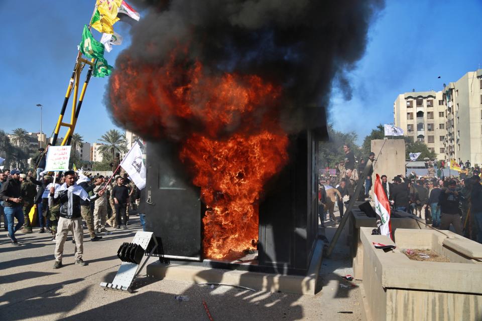 Protesters burn property in front of the U.S. embassy compound, in Baghdad, Iraq, Tuesday, Dec. 31, 2019. (Photo: Khalid Mohammed/AP)