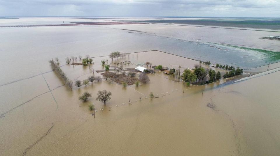 A farming ranch is surrounded by floodwater in the old Tulare Lake basin area of Kings County south of Corcoran on Thursday, March 23, 2023. CRAIG KOHLRUSS/ckohlruss@fresnobee.com