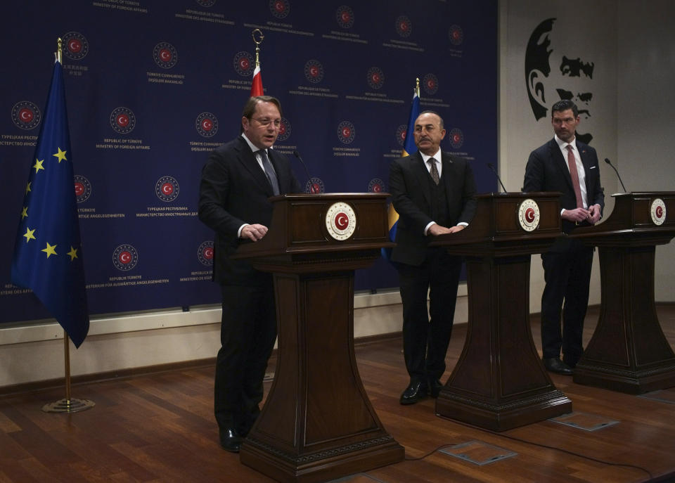 Turkey's Foreign Minister Mevlut Cavusoglu, centre, European Commissioner for Neighbourhood and Enlargement Oliver Varhelyi, left, and Sweden's Minister for International Development Cooperation and Foreign Trade Johan Forssell speak at a joint news conference in Ankara, Turkey, Wednesday, Feb. 22, 2023. Varhelyi and Forssell are in town to prepare for the International Donor's Conference, scheduled for March in Brussels, and aimed at mobilizing funds from the international community to support Turkey and Syria following the quakes.(AP Photo/Burhan Ozbilici)