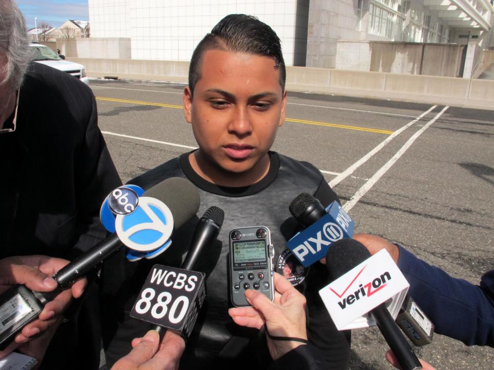 In this Monday, March 31, 2014 photo, Joshua Argueta speaks to the media outside the U.S. District Courthouse in Central Islip, N.Y. Argueta attended the arraignment of Juan Elias Garcia, who is accused of murdering Argueta's sister Vanessa and her 2-year-old son Diego Torres. Garcia, who was on the FBI's list of "Ten Most Wanted Fugitives" until his capture in Nicaragua last week, pleaded not guilty and is being held without bail. (AP Photo/Frank Eltman)