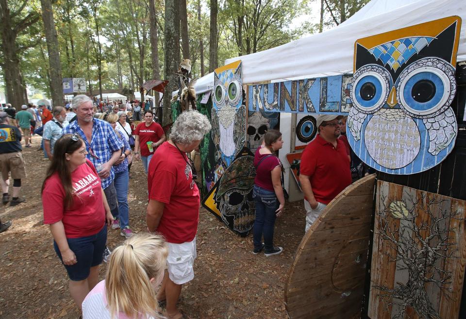 Guests look at the many different tents set up at the 43rd annual Kentuck Festival of the Arts in downtown Northport on Saturday, Oct. 15, 2016.