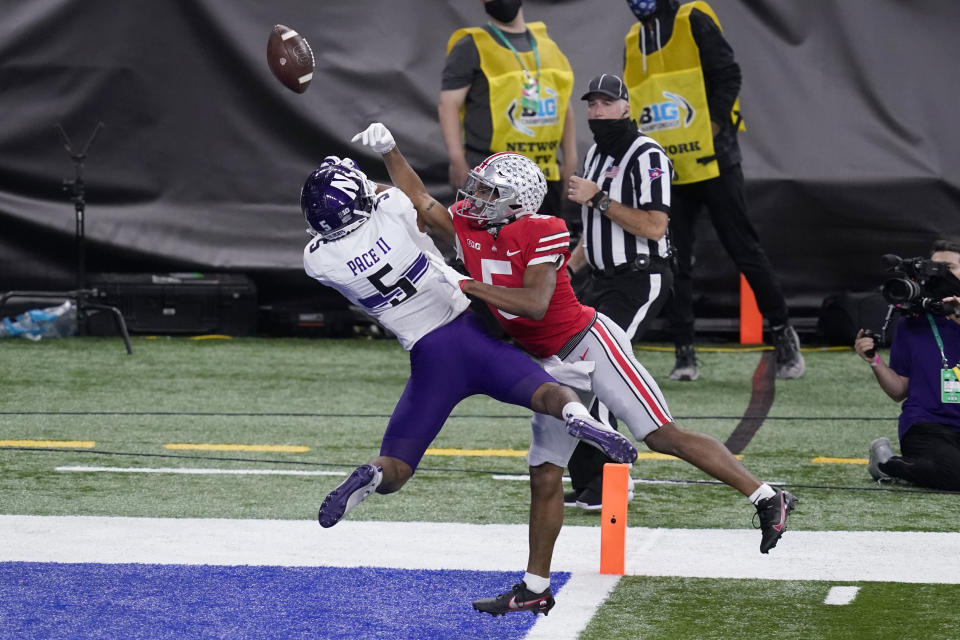 Ohio State wide receiver Garrett Wilson, right, is unable to reach a pass as Northwestern defensive back JR Pace defends during the second half of the Big Ten championship NCAA college football game, Saturday, Dec. 19, 2020, in Indianapolis. (AP Photo/Darron Cummings)