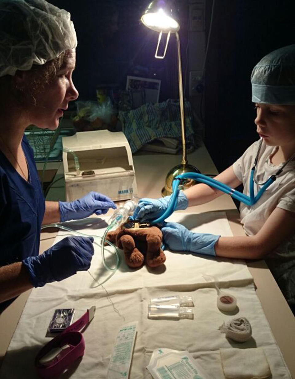 Luanne Willingham helps her youngest child, Ethan, perform surgery on Scaredy Squirrel. She thinks he will follow in her footsteps and take on a medical career someday. Source: Luanne Willingham