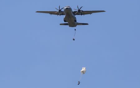 A Polish Casa C-295 drops cargo bags with parachutes during joint training exercises of the Canada's 3rd Battalion Princess Patricia's Canadian Light Infantry, U.S. Army's 173rd Infantry Brigade Combat Team and the Polish 6 Airborne Brigade soldiers at Land Forces Training Centre in Oleszno near Drawsko Pomorskie, northwest Poland, in this June 9, 2014 file photo. REUTERS/Przemyslaw Szyszka/Files