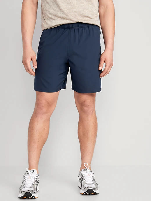 model wears navy blue Essential Woven Workout Shorts.