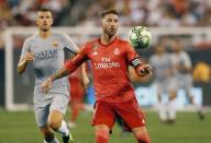 FILE PHOTO: Aug 7, 2018; East Rutherford, NJ, USA; Real Madrid midfielder Sergio Ramos (4) plays the ball against Roma forward Edin Dzeko (9) during an International Champions Cup soccer match at MetLife Stadium. Mandatory Credit: Noah K. Murray-USA TODAY Sports