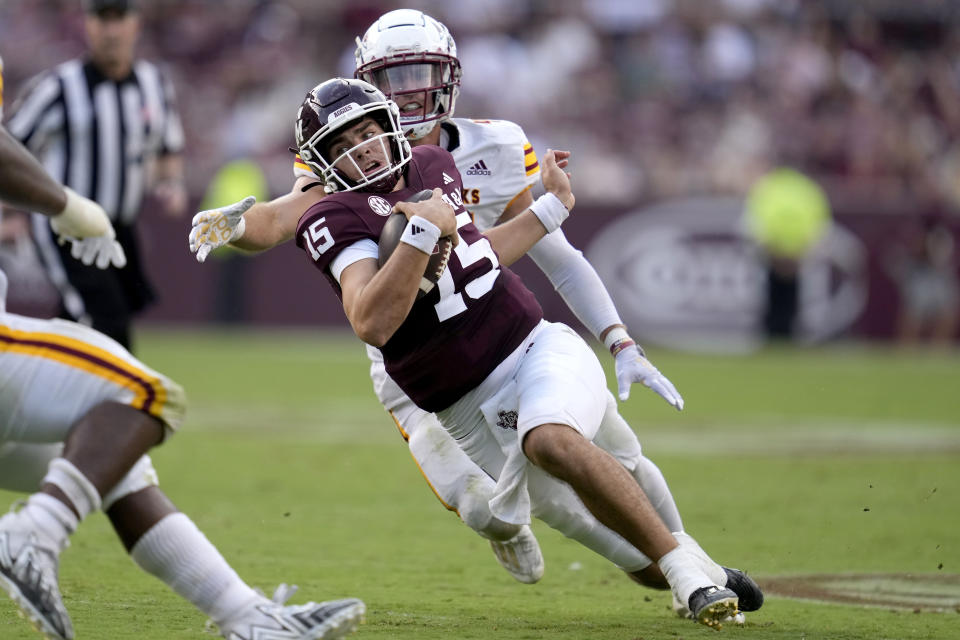 Texas A&M quarterback Conner Weigman (15) is chased down out of the pocket by Louisiana-Monroe linebacker Michael Batton, right, for a short gain during the second half of an NCAA college football game Saturday, Sept. 16, 2023, in College Station, Texas. (AP Photo/Sam Craft)