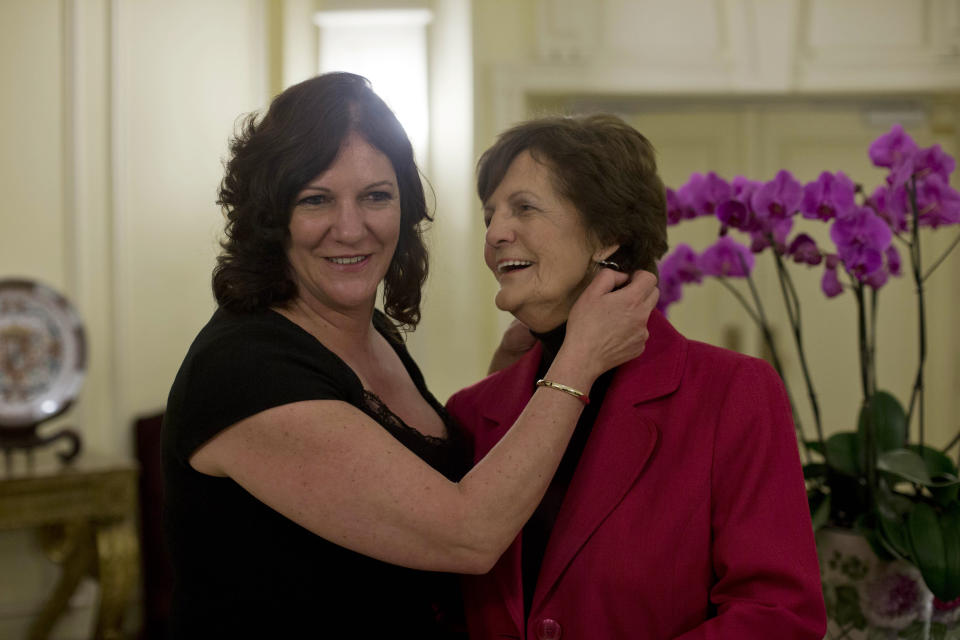 Philomena Lee, right, and her daughter Jane Libberton pose for photos at the end of a press conference in Rome, Thursday, Feb. 6, 2014, after her meeting with Pope Francis a day earlier and the Oscar-nominated film based on her story of trying to find a son taken from her 50 years earlier. One of the main criticisms of the Vatican in a U.N. report on sex abuse was the Holy See's failure to investigate the arbitrary placement of girls in church-run workhouses in Ireland, where their out-of-wedlock babies were taken from them and put up for adoption. (AP Photo/Andrew Medichini)