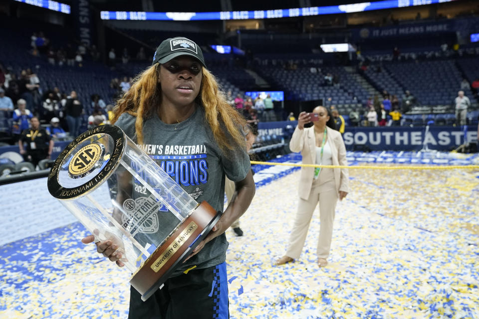 Kentucky's Rhyne Howard carries the trophy after Kentucky beat South Carolina in the NCAA women's college basketball Southeastern Conference tournament championship game Sunday, March 6, 2022, in Nashville, Tenn. (AP Photo/Mark Humphrey)