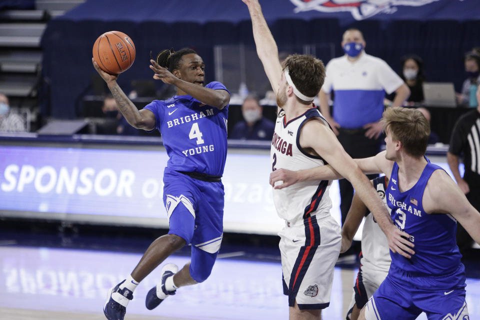 FILE - In this Thursday, Jan. 7, 2021 file photo, BYU guard Brandon Averette (4) prepares to pass the ball while pressured by Gonzaga forward Drew Timme (2) during the second half of an NCAA college basketball game in Spokane, Wash. Heading into the season, there wasn't a lot of talk about No. 23. BYU. This was supposed to be a rebuilding season in Provo, Utah for coach Mark Pope and his Cougars. Guess again. BYU went 20-6 playing with a returning senior guard, three transfers and a freshman and they seemingly are getting better heading into their first NCAA Tournament since 2015. (AP Photo/Young Kwak)