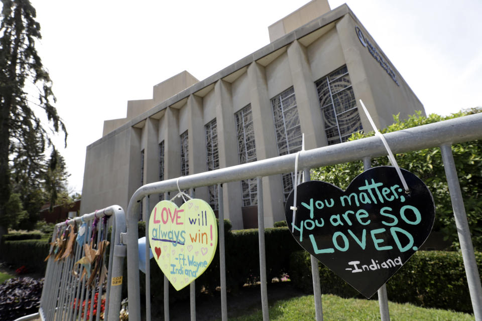 FILE - Signs hang on a fence surrounding the Tree of Life synagogue in Pittsburgh on Sept. 17, 2019. Prosecutors told a federal judge, Thursday, Dec. 2, 2021, in a new filing that the Pittsburgh synagogue massacre defendant’s statements at the scene should be allowed for use at trial, in part because concerns about public safety in the immediate aftermath were a valid reason to keep questioning him. (AP Photo/Gene J. Puskar, File)