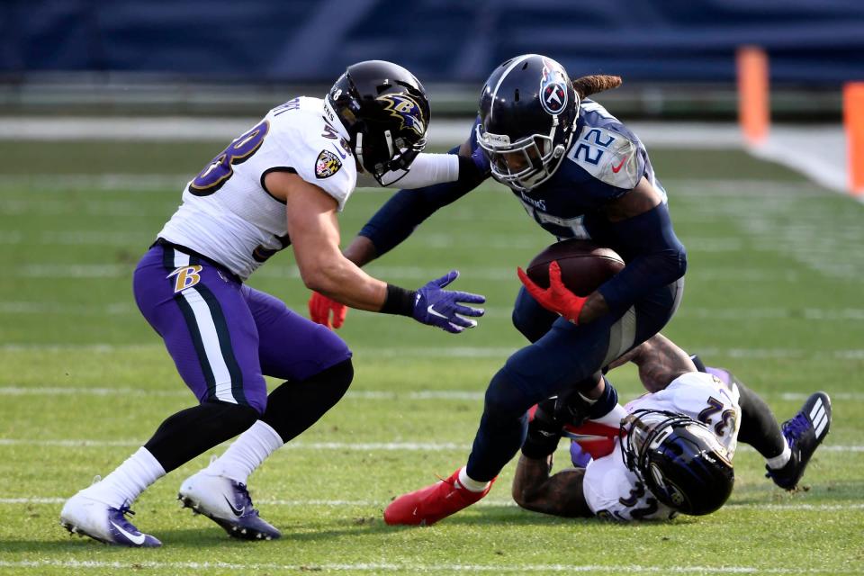 Tennessee Titans running back Derrick Henry (22) is tackled by Baltimore Ravens inside linebacker L.J. Fort (58) and  Baltimore Ravens safety DeShon Elliott (32) during the Tennessee Titans game against the Baltimore Ravens in Nashville on January 10, 2021. 