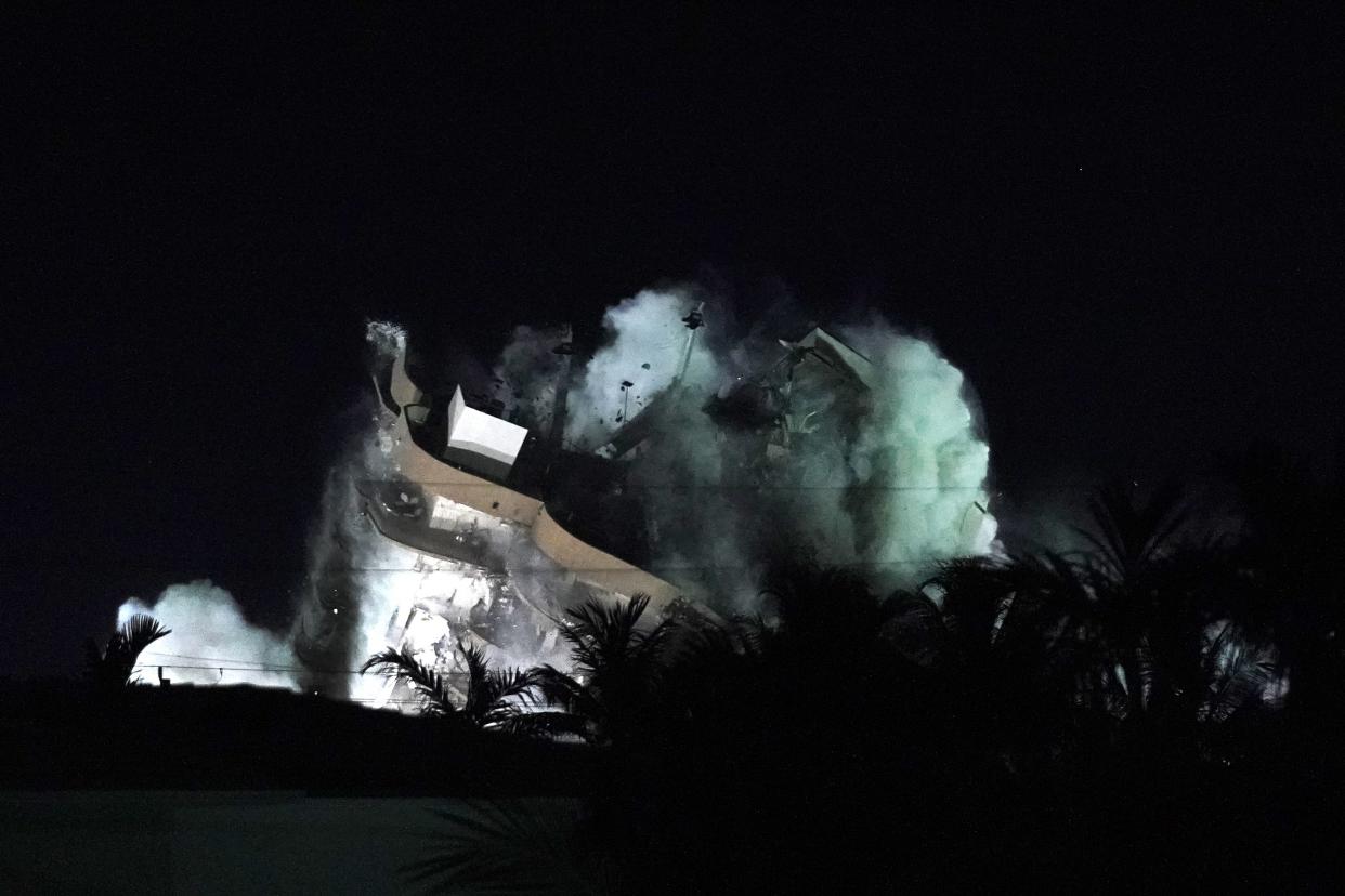 Demolition teams bring down the unstable remainder of the Champlain Towers South condo building, late Sunday, July 4, 2021, in Surfside, Fla. The work to demolish the remains had suspended the search-and-rescue mission, but officials said Sunday it should eventually open up new areas for rescue teams to explore.