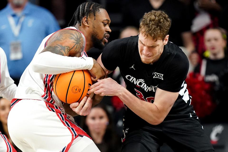 Houston Cougars forward J'Wan Roberts (13) and Cincinnati Bearcats forward Viktor Lakhin (30) compete for a rebound Saturday. Houston gained their 10th straight win over UC, 67-62.