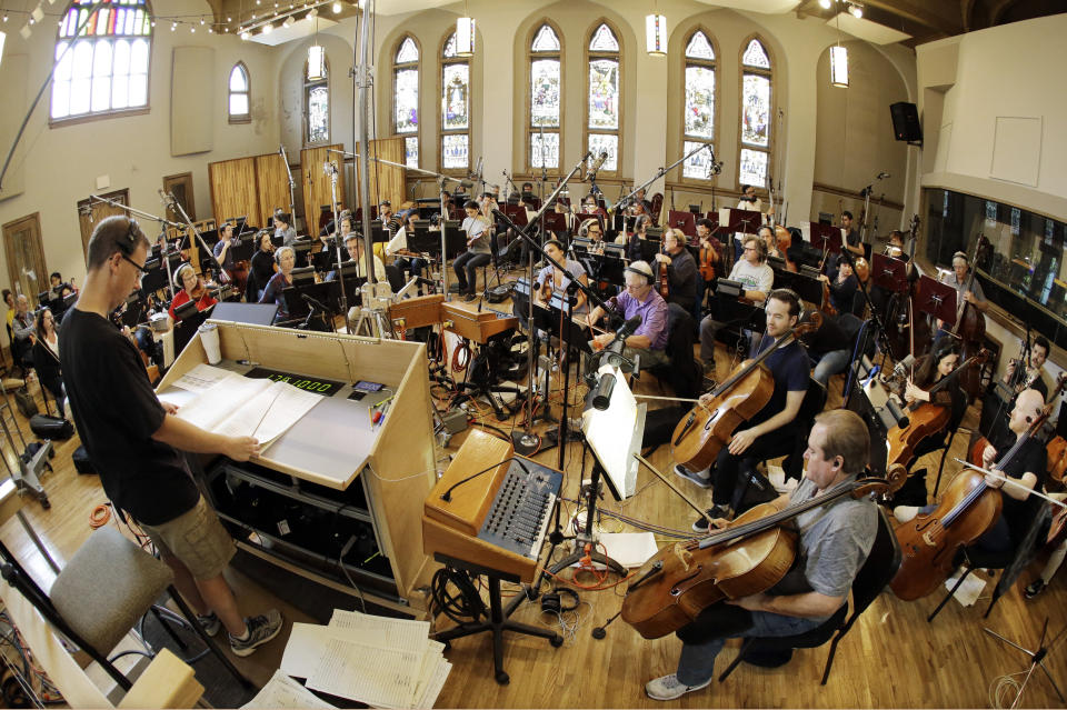 In this Oct. 21, 2019, photo, conductor David Shipps, front left, directs the orchestra during the recording of a video game soundtrack in Nashville, Tenn. Music City is earning a new reputation as Soundtrack City. And more production companies, including Netflix, Showtime, Sony and Focus Features, have been lured to Nashville to record music for movies, TV and video games in the last year thanks to a new incentive program. (AP Photo/Mark Humphrey)