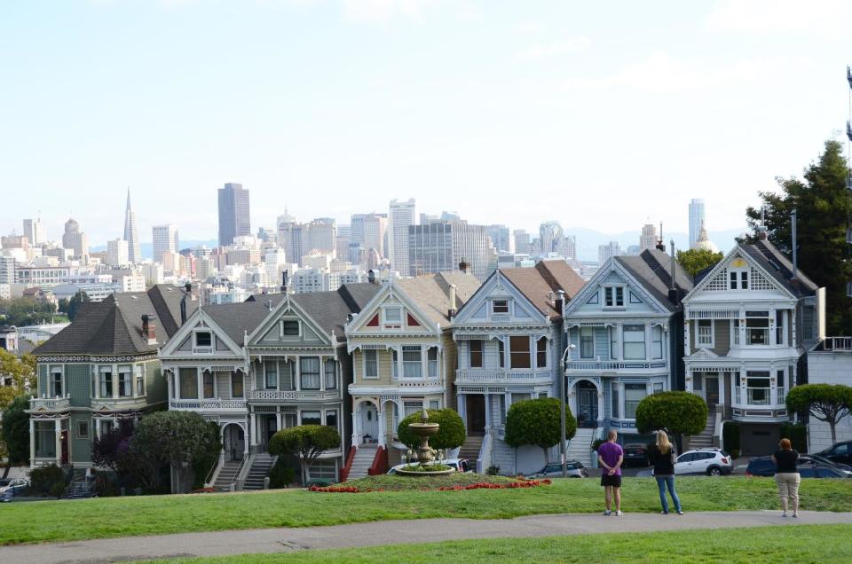 This October 2011 photo shows an escalating row of Victorian houses known as “Painted Ladies” on the edge of Alamo Square Park, overlooking the San Francisco skyline, at the start of a Streets of San Francisco bike tour. SoSF offers trips ranging from eight to 18 miles and a wide variety of historic and cultural sites. (AP Photo/Paula Froke)