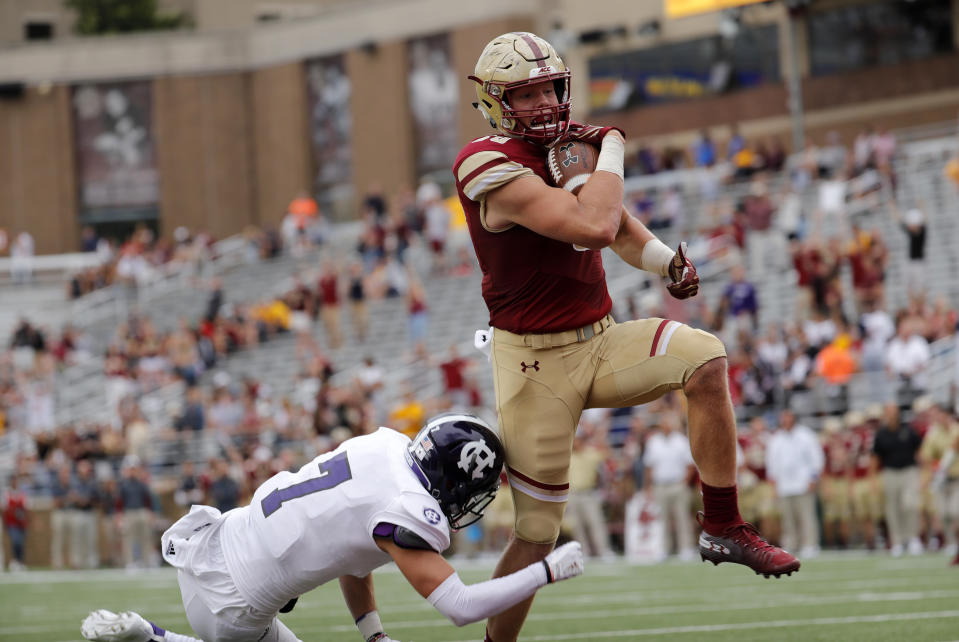 CHESTNUT HILL, MA - SEPTEMBER 08: Boston College tight end Hunter Long (80) scores a touchdown as Holy Cross defensive back Chris Riley (7) tries to stop him during a game between the Boston College Eagles and the Holy Cross Crusaders on September 8, 2018, at Alumni Stadium in Chestnut Hill, Massachusetts. The Eagles defeated the Crusaders 62-14. (Photo by Fred Kfoury III/Icon Sportswire via Getty Images)